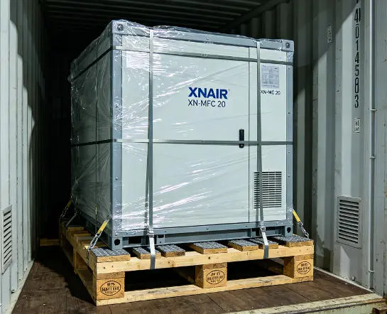 XNAIR mobile cold storage unit secured on fumigated timber cradle with steel edge protectors and vapor-proof wrapping inside 40ft shipping container for ocean export